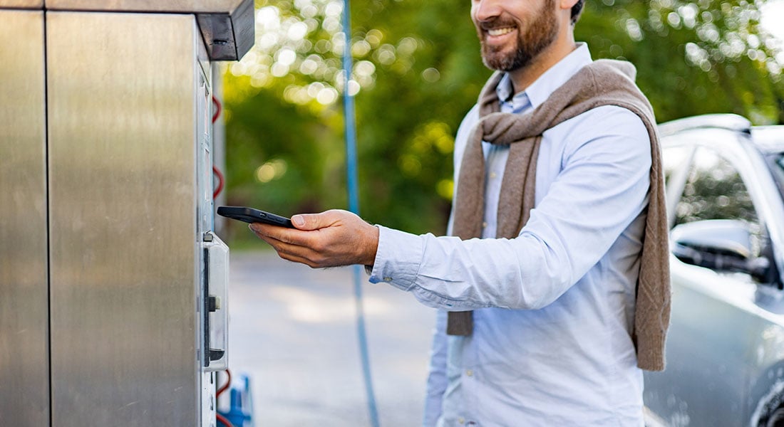 customer making a payment at a car wash kiosk