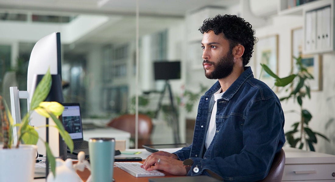 software developer working on payment integration at a computer